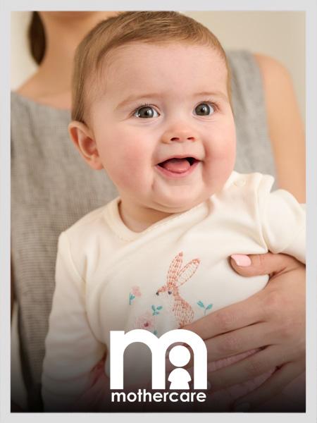 Happy baby in a cream long-sleeved bodysuit with an embroidered pink rabbit design. Mothercare baby clothing.