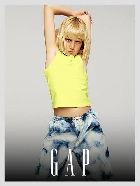 GAP kids wearing a neon yellow tank top and blue tie-dye sweatpants.