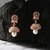The Nila Rose Gold Pale Pink Stone Crystal Studded Jhumkas