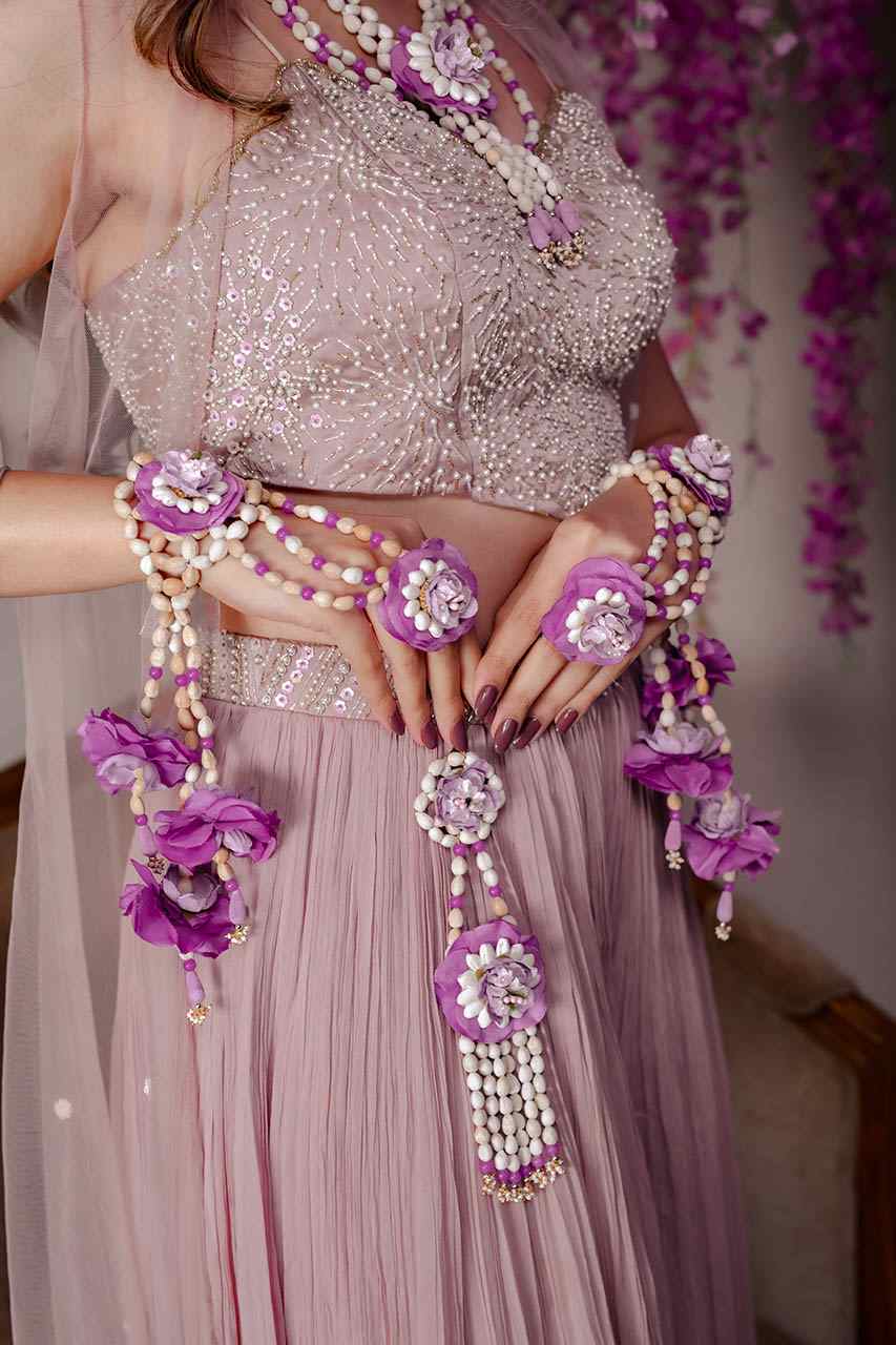 A pair of Thai tagar hathphool with purple flowers & tassels