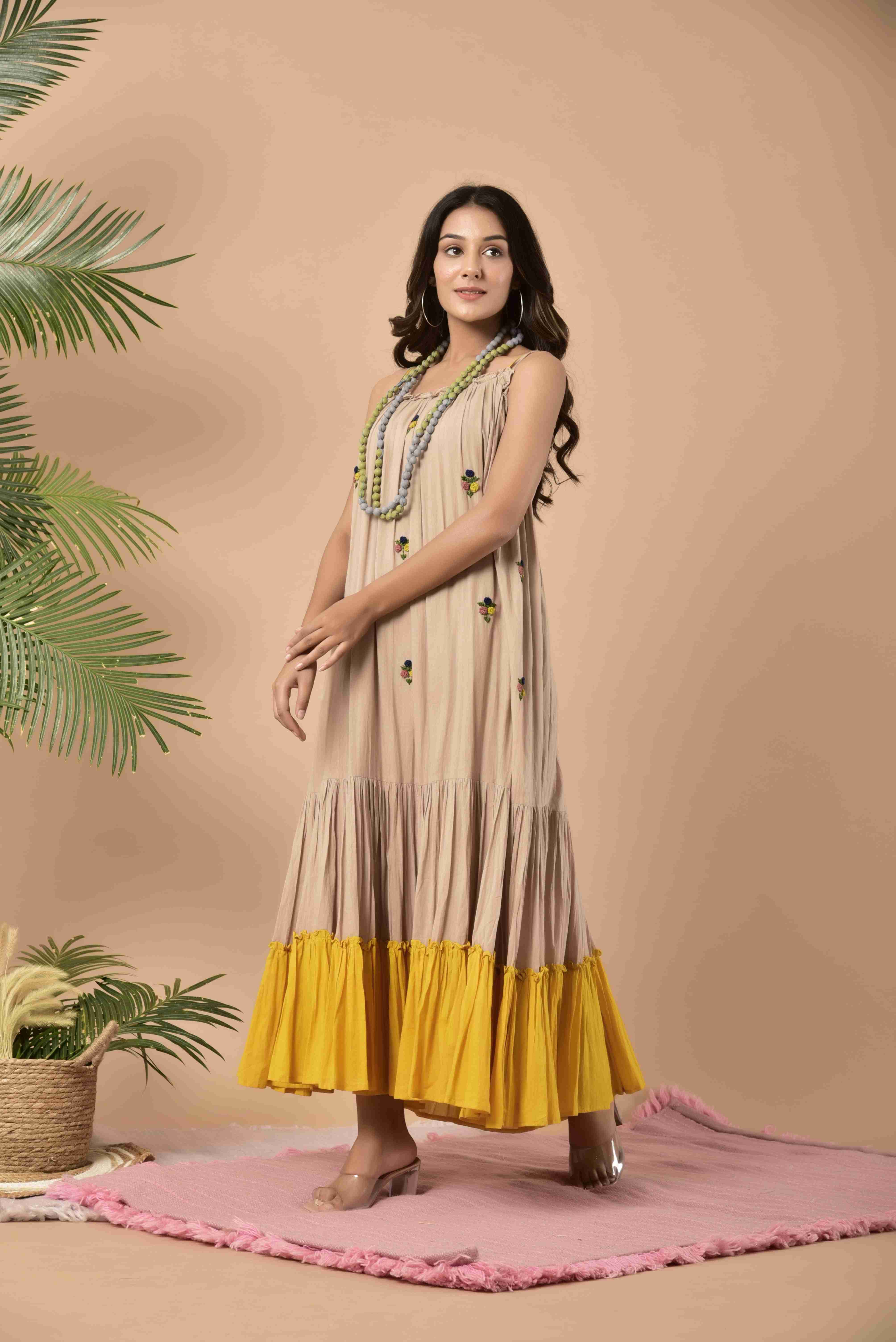 Beige and yellow mulmul anchor spaghetti dress with anchor hand work on the first panel layered ankle length dress and the last layer is yellow