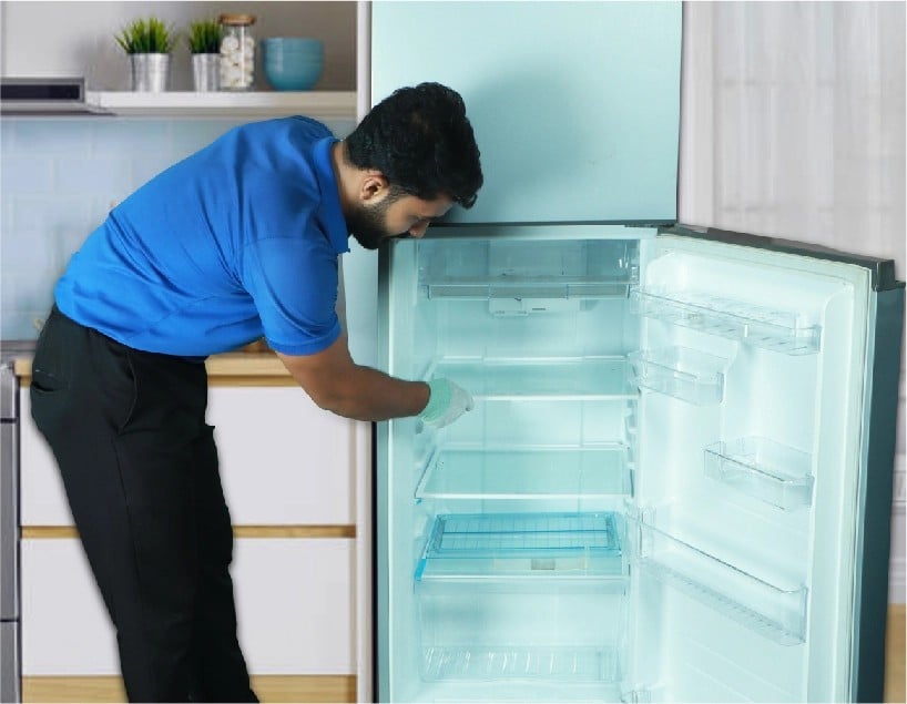 resQ technician cleaning refrigerator interior during routine service