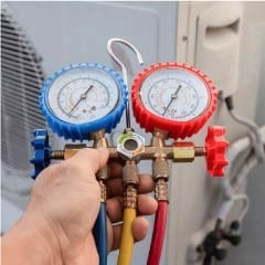 resQ technician performing gas charging on an AC compressor