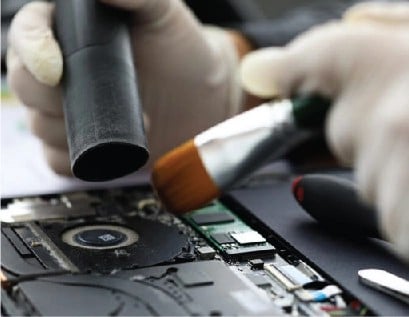 resQ technician cleaning laptop internals during preventive check
