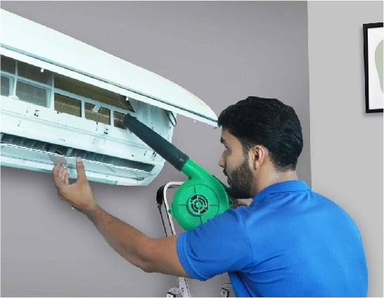 resQ technician performing jet/wet service on an AC unit