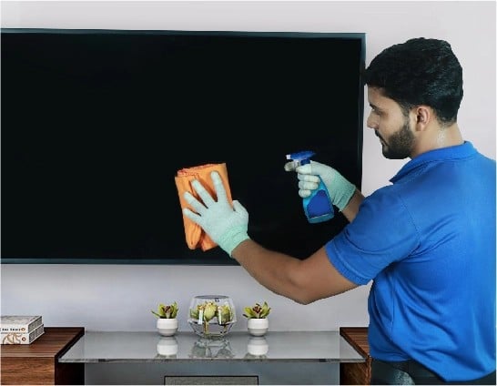 resQ technician cleaning TV screen during routine service