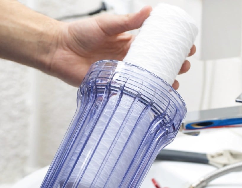 resQ technician replacing water purifier filter cartridge