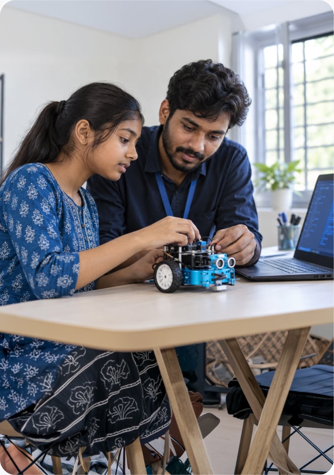 A child learning digital skills alongside a robot