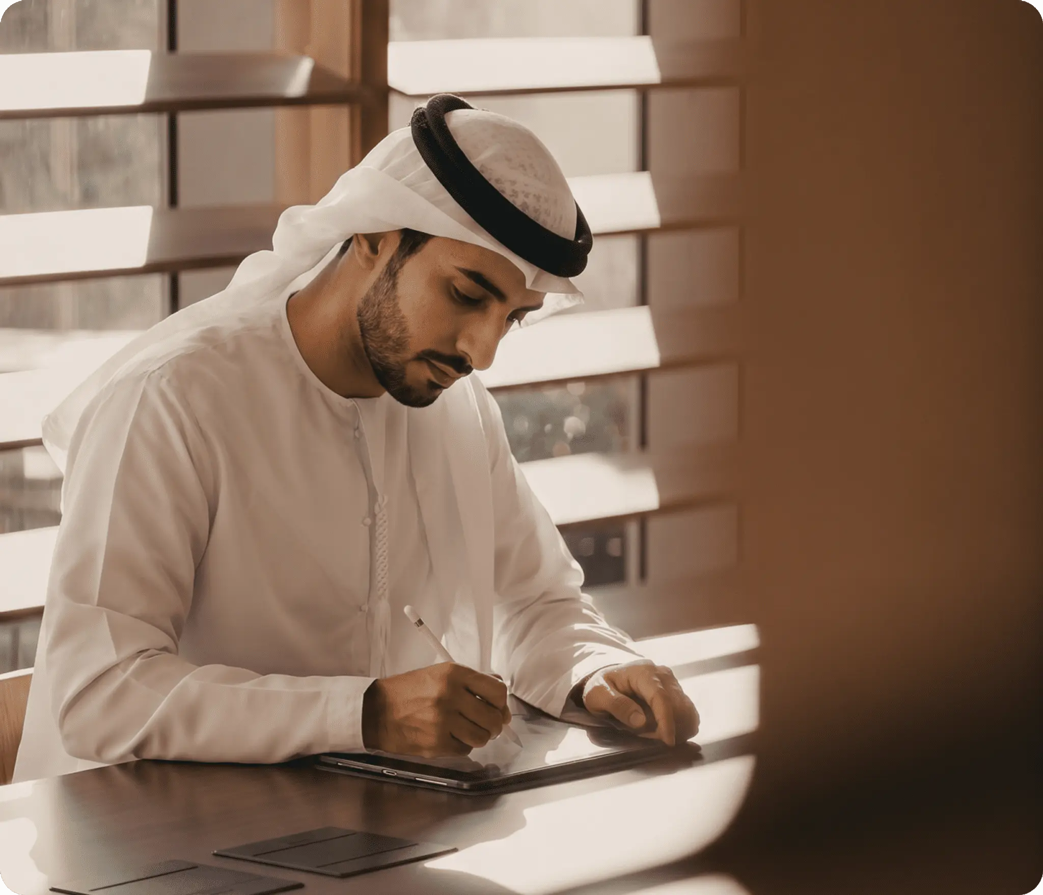 GCC retail operator writing on a tablet during launch planning