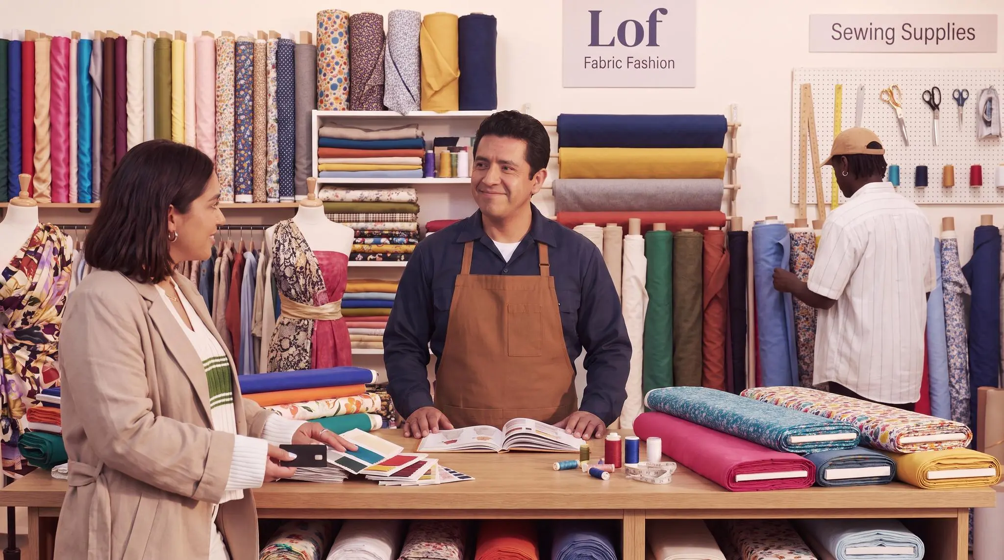 Sourcing and production team reviewing fabric swatches at a textile supplier