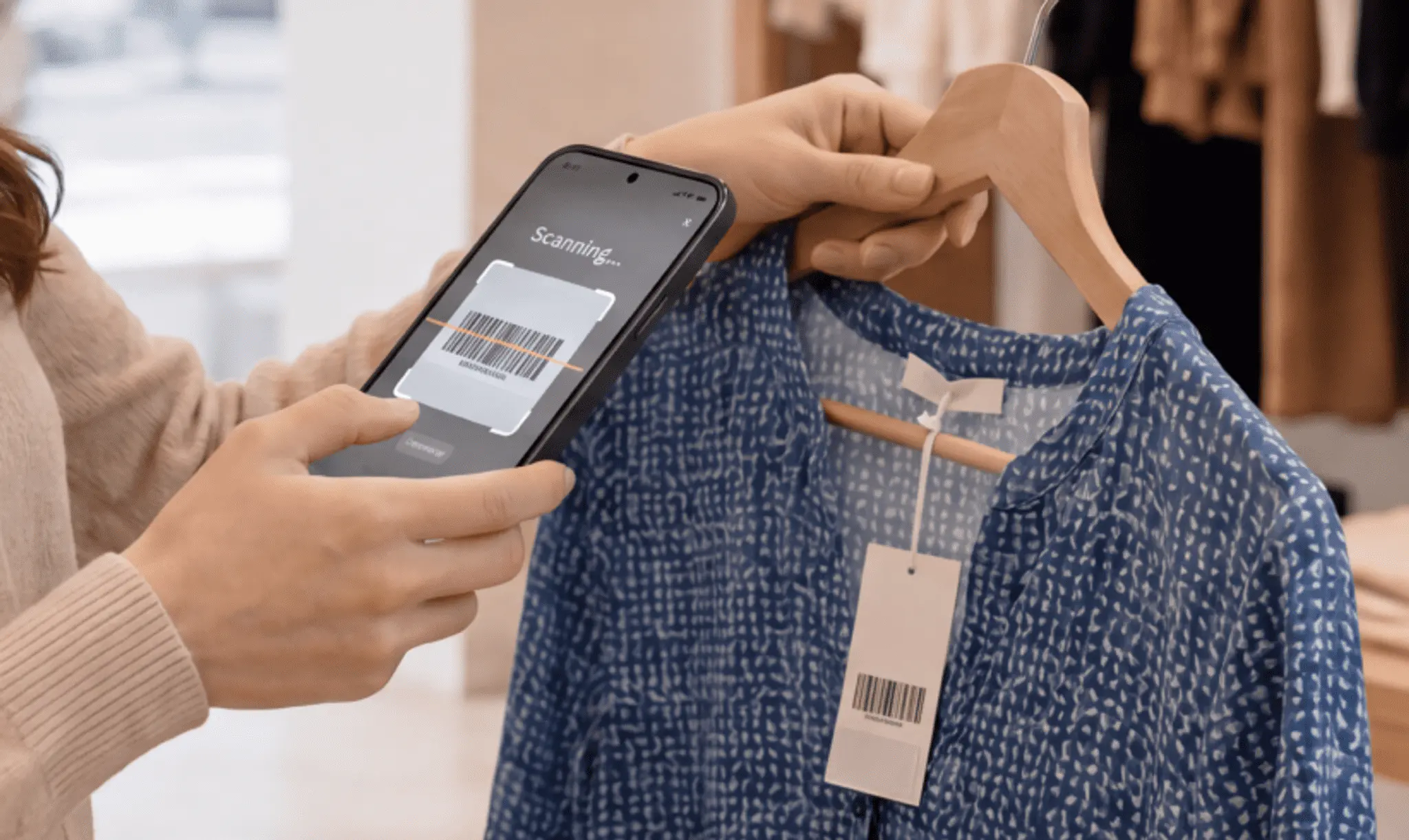 Customer scanning a garment's barcode tag with a smartphone camera