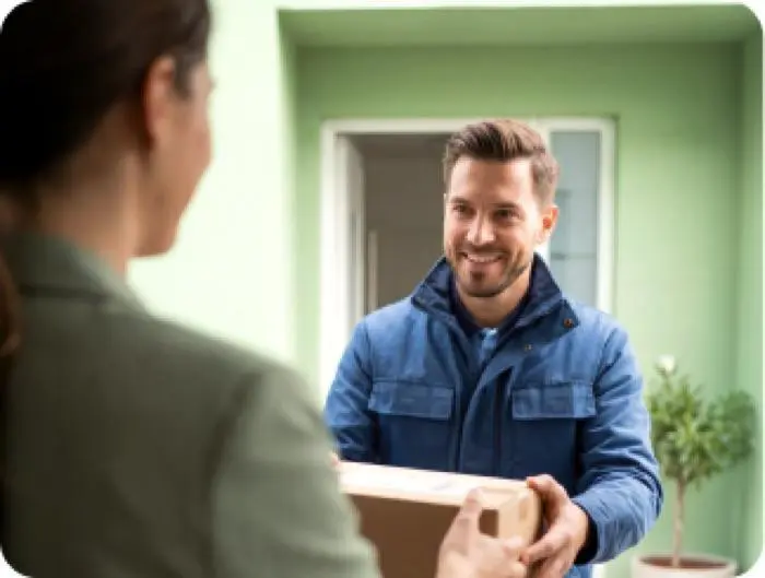 Delivery courier handing a package to a customer at their doorstep