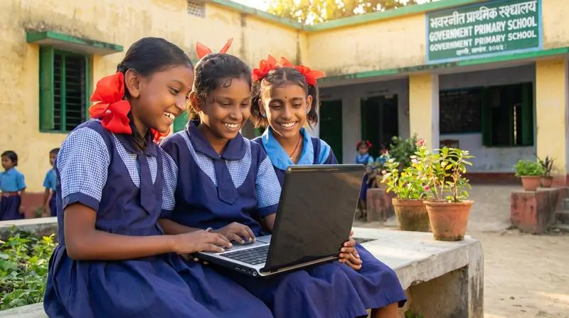 Students learning together with a laptop