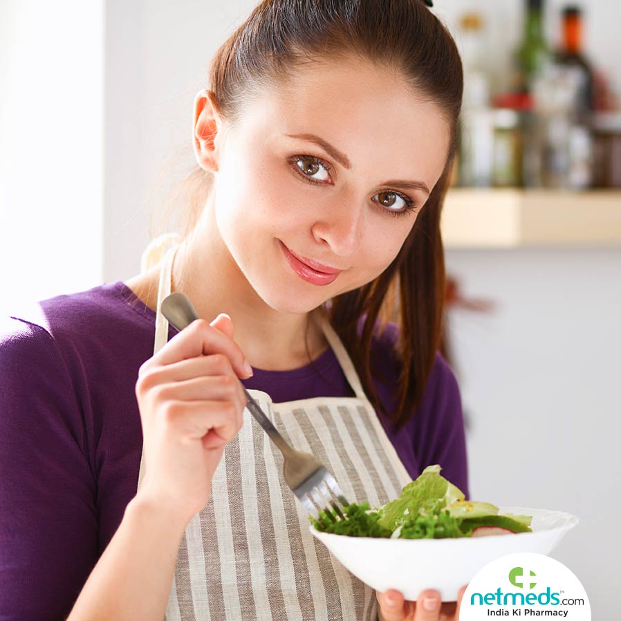 Woman eating vegetables