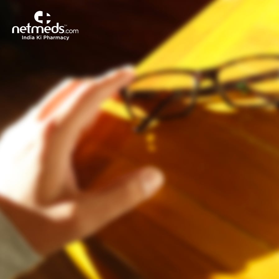 A hand touching the spectacles