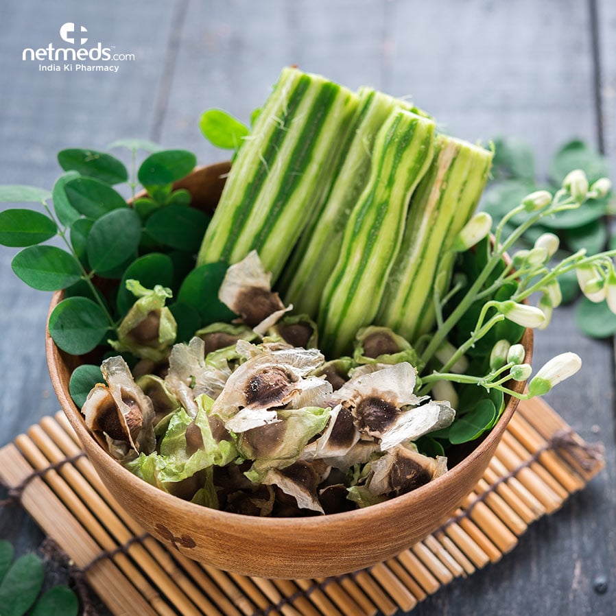 Drumstick, leaves, flowers and seeds in a bowl