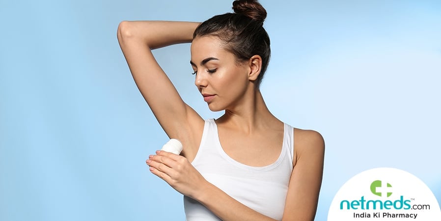 woman applying deodorant