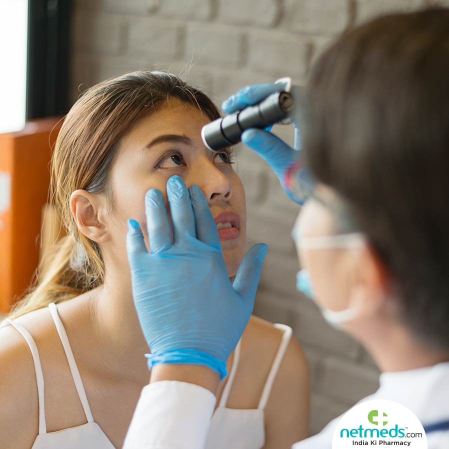 Doctor doing eye check-up to a girl