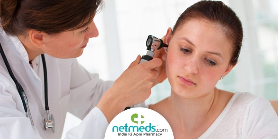 Doctor checking a woman's ear
