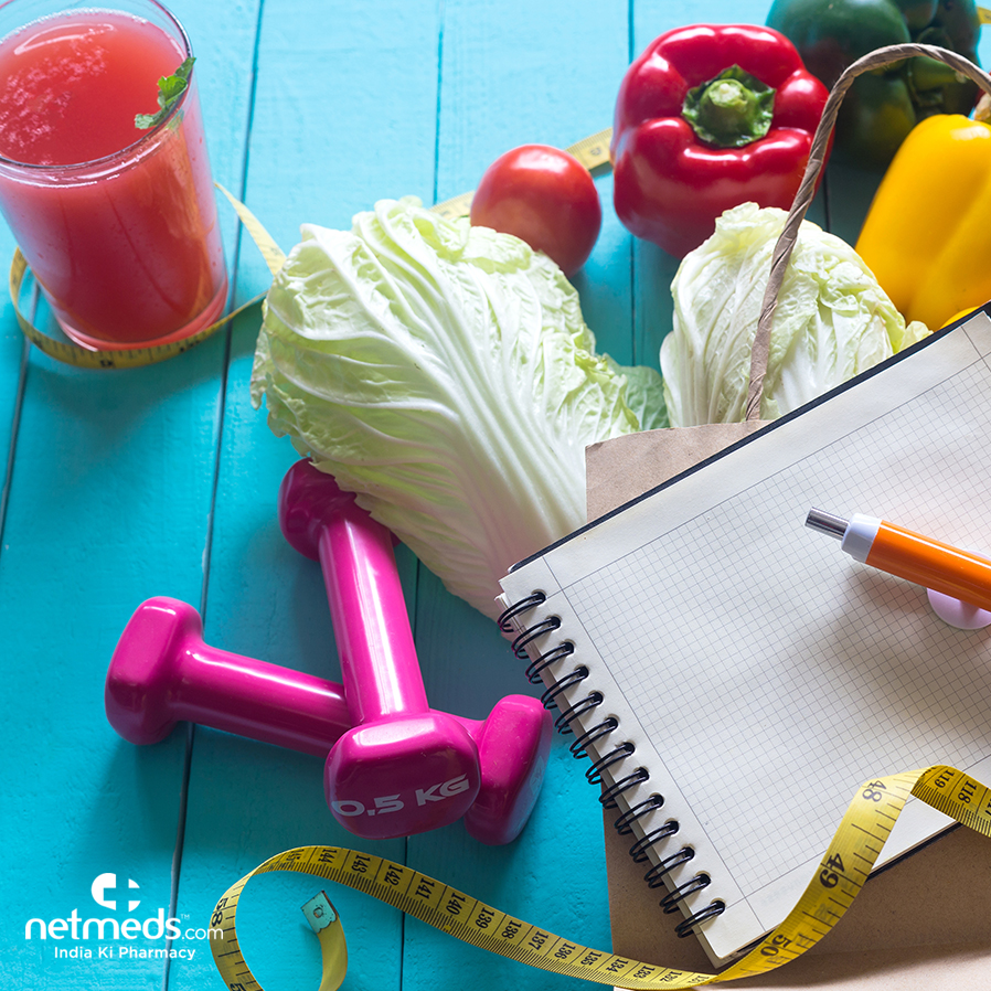 Juice, vegetables, measuring tape and dumbbells
