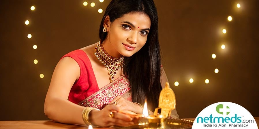 Woman lighting a lamp in festive look