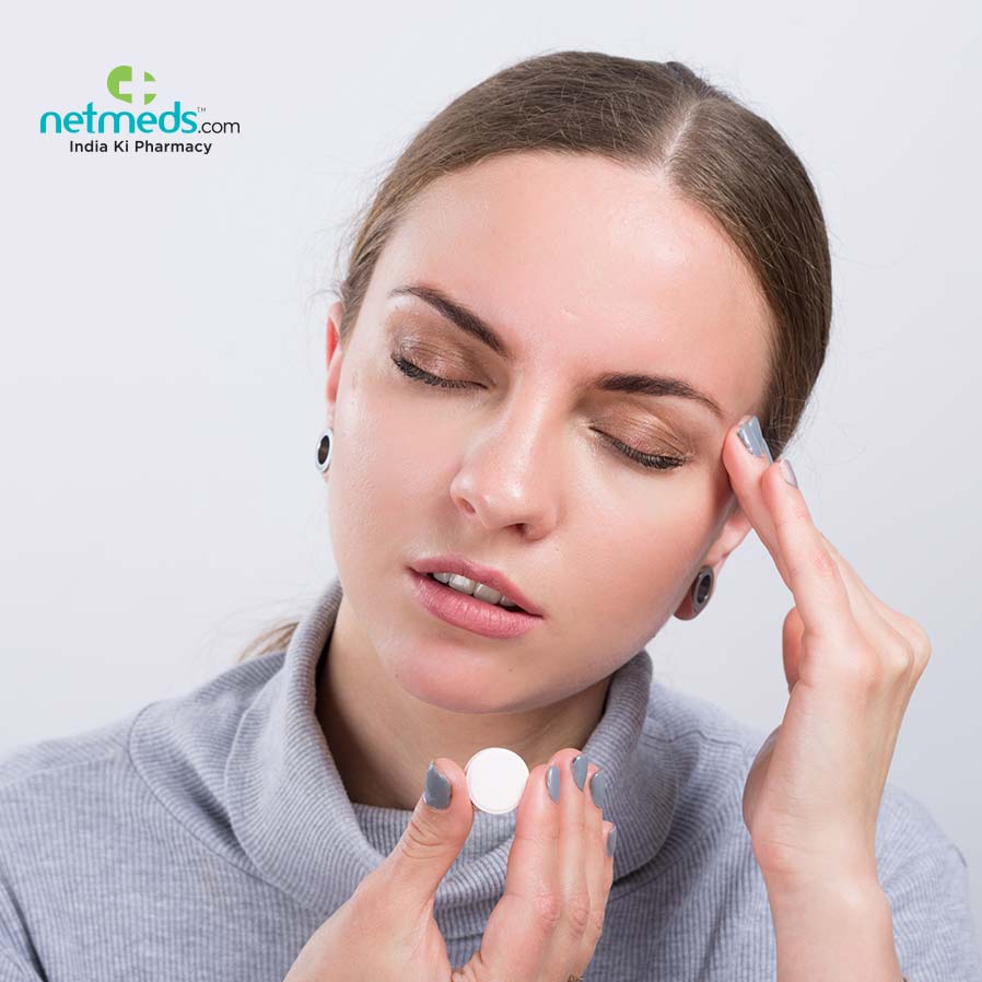 Girl taking tablet for headache