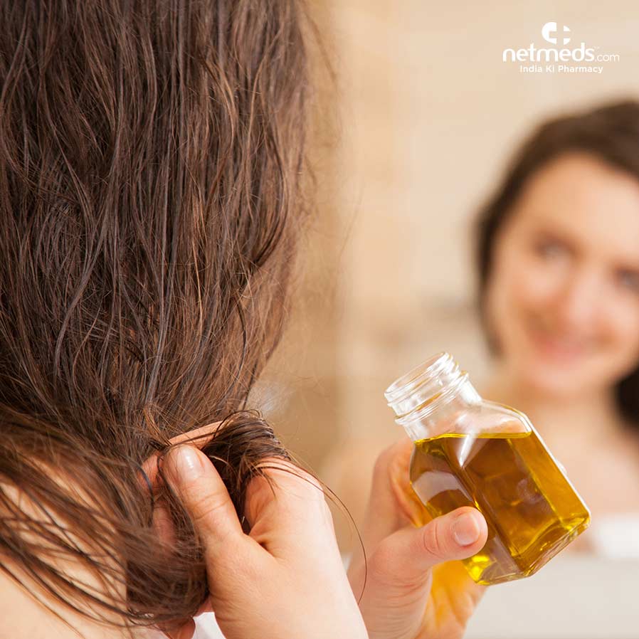 Woman applying Natural oil for Frizzy hair