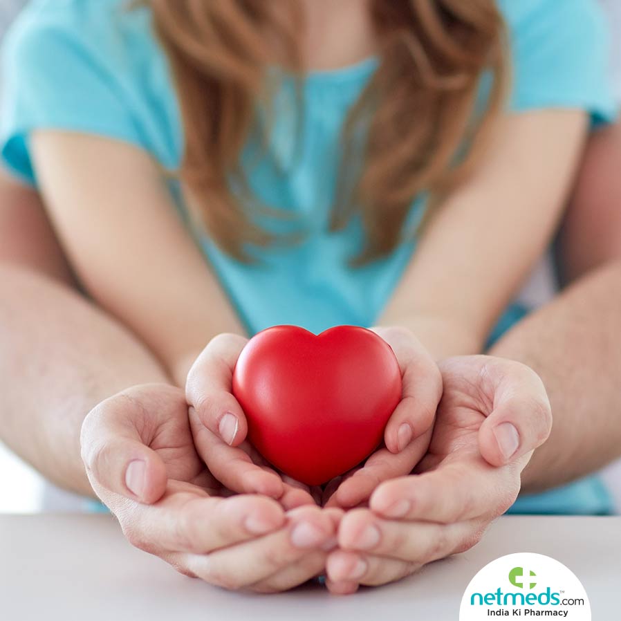 Father and daughter holding a heart