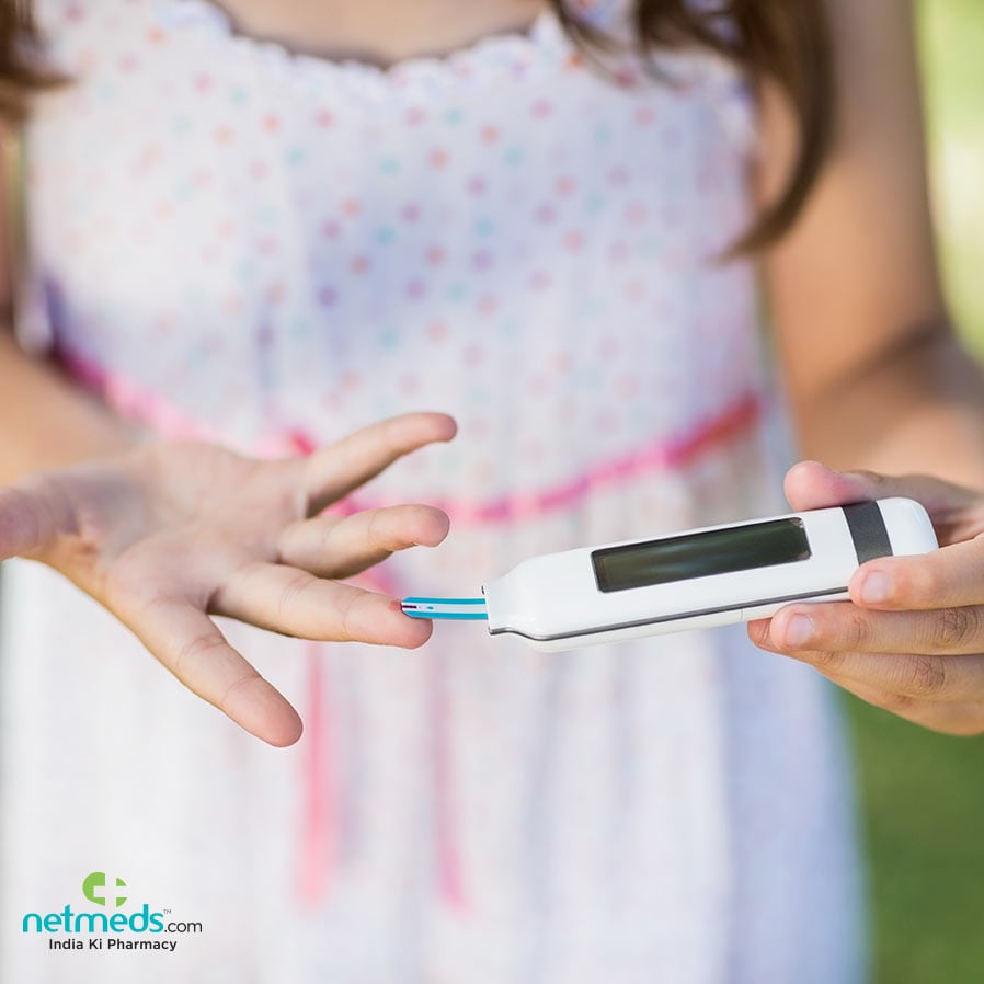 Kid checking diabetes with glucometer