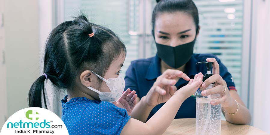 Mother giving sanitizer to the kid