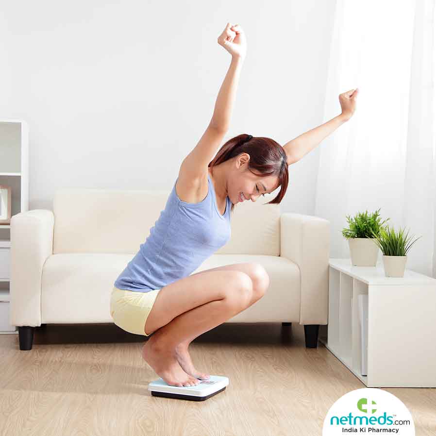 Girl checking her weight happily