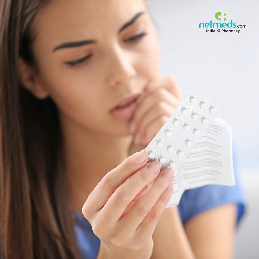 Girl reading the instructions provided with the birth control pills