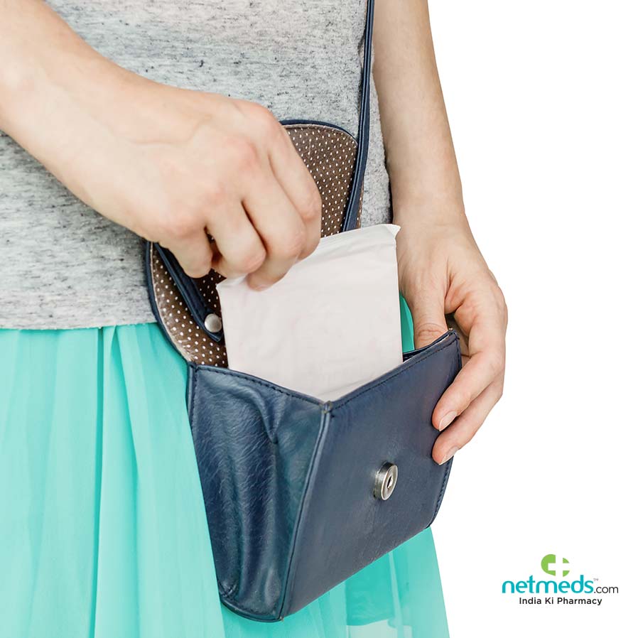 Girl taking sanitary napkin from handbag