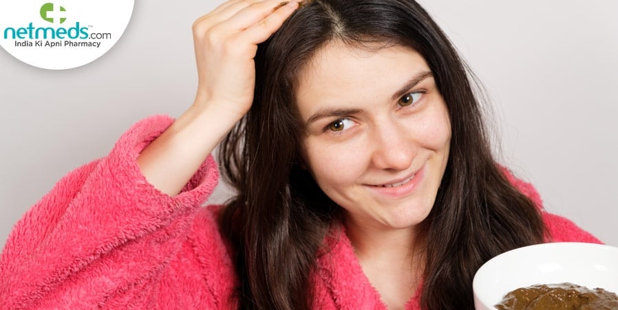 Woman applying scalp scrub
