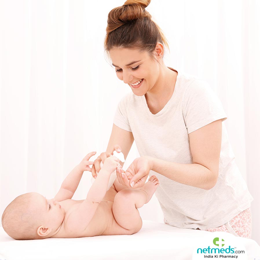 Mother applying lotion to baby