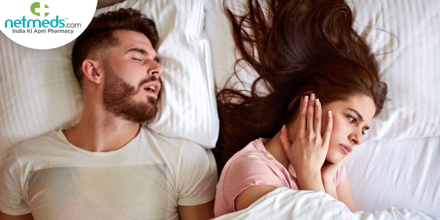 Man snoring and woman closing her ears