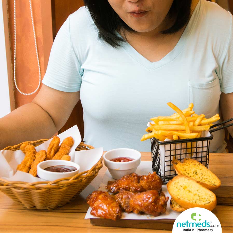 Woman sitting in front of junk foods