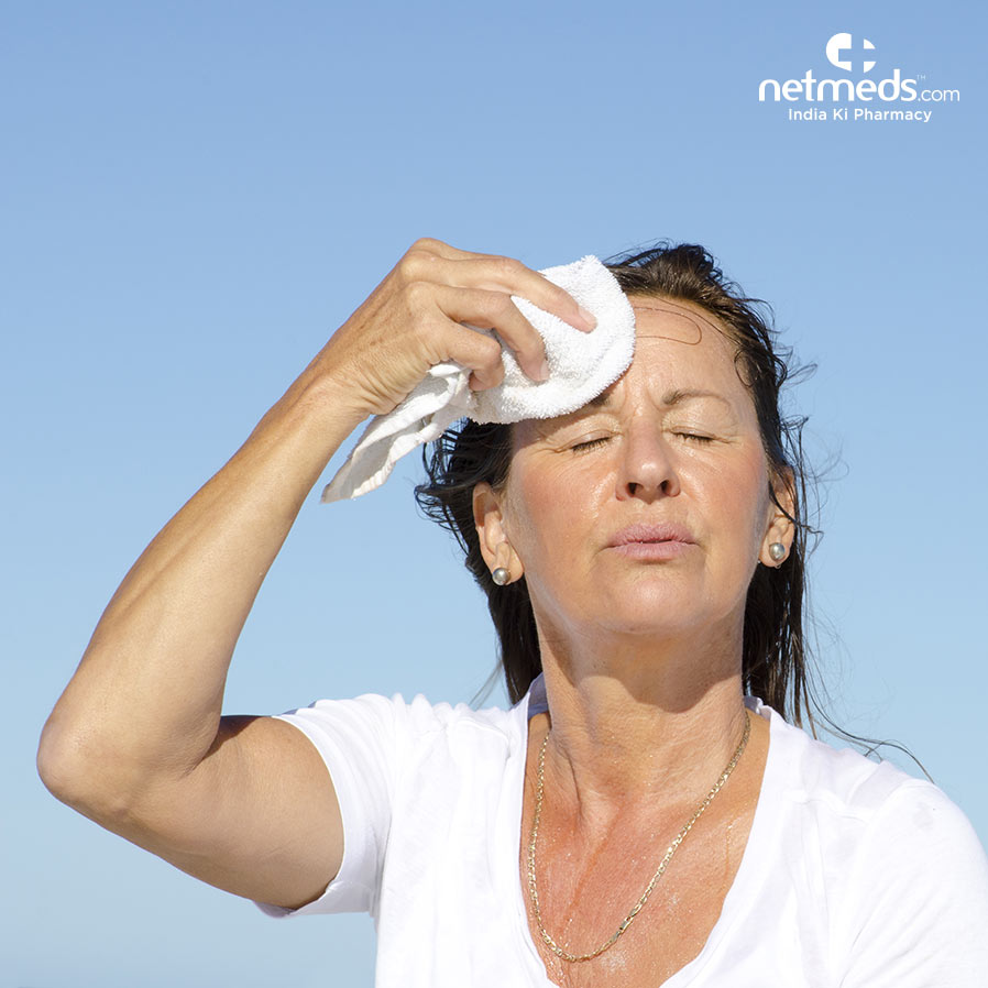 Woman wiping her sweat with a towel
