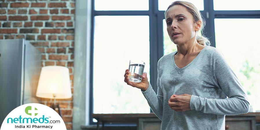 Woman drinking water for hot flashes