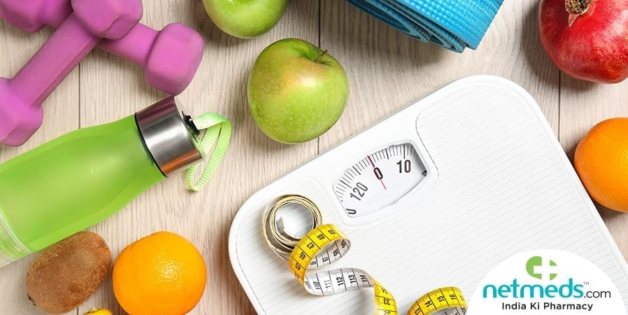 Weighing machine, water bottle, dumbles and fruits