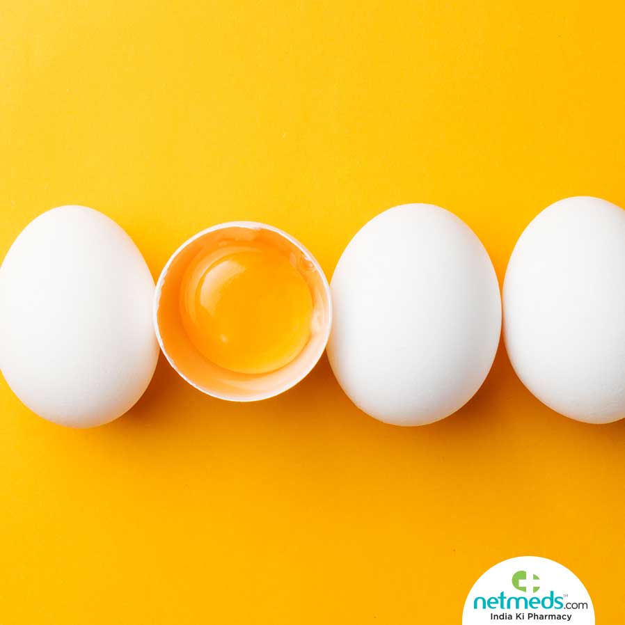 Three whole eggs and one egg with yolk shown