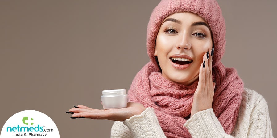 Woman applying cream in winter