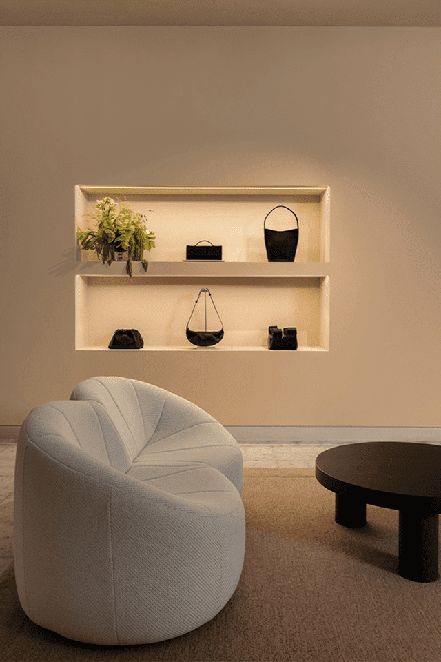 COS store lounge area with shelves and a rounded chair